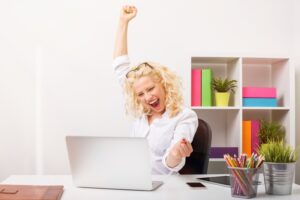 Beuatifull woman at the office celebrating her success