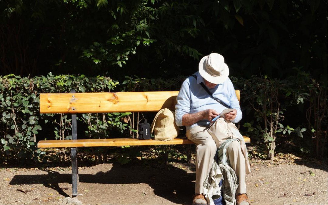 elderly man looking at papers